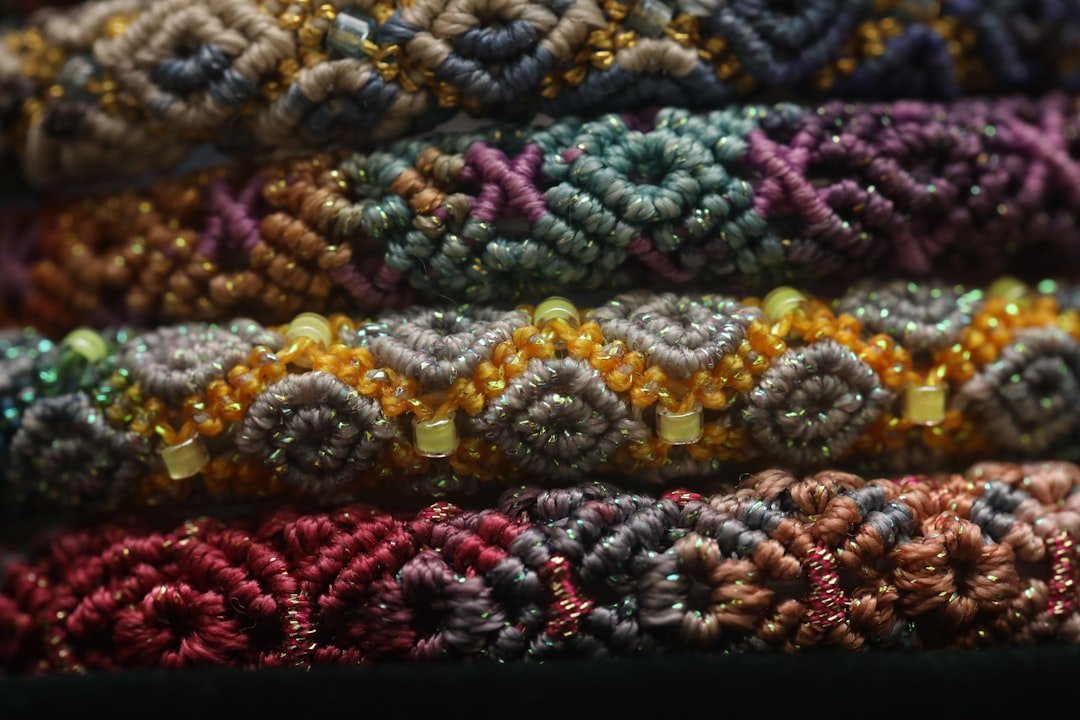 stack-of-colorful-woven-bracelets-with-intricate-patterns-i0rnp9auqbc